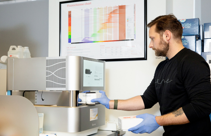 Stephen Gire in the lab with the Illumina NextSeq 2000 | Photo: Angela DeCenzo