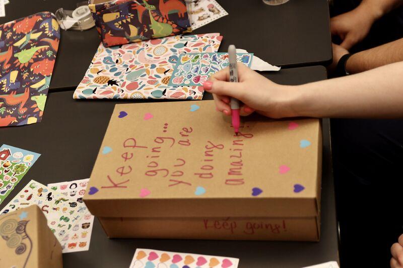 hand writing on a shoe box "keep going you are doing great"