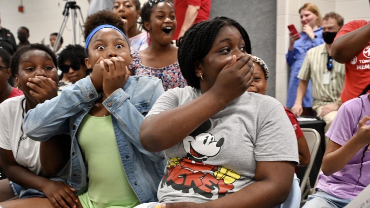 children gasp, and have hands over their mouths, some have huge smiles