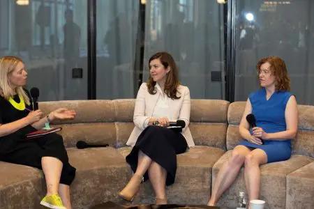 Mary Jacques and two others with microphones on a circular couch.