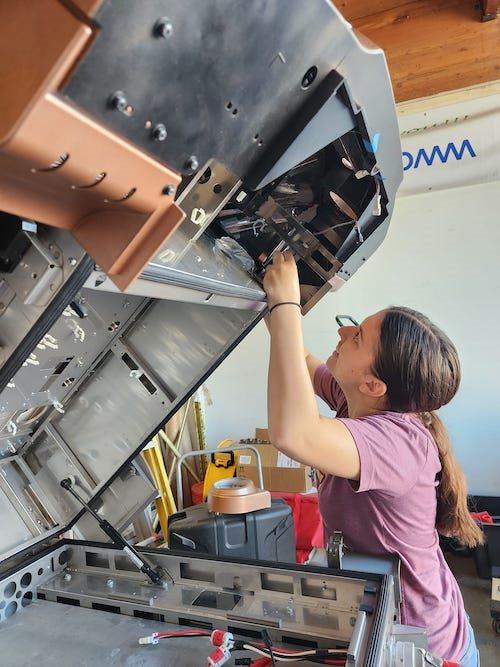 A person working on a tilted machine.