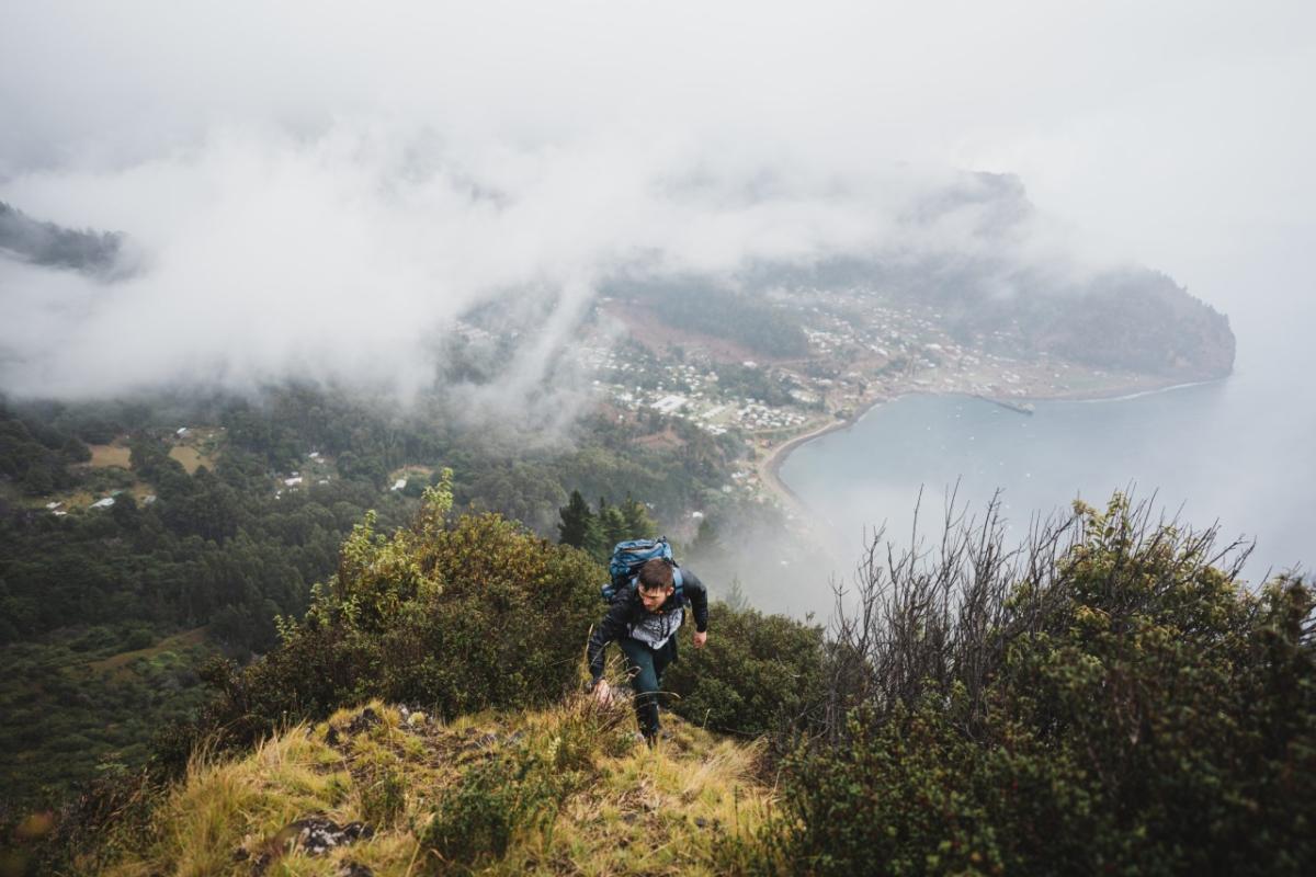 Worker hiking a mountain