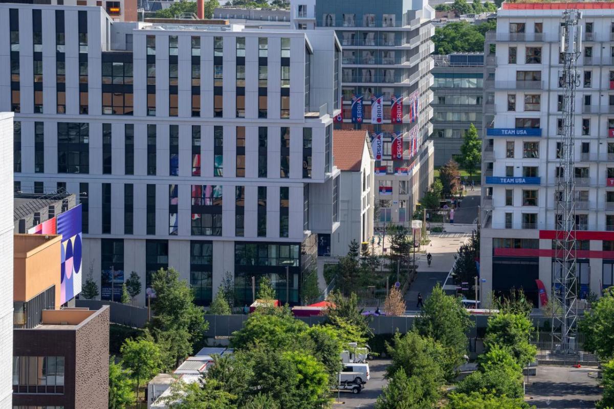 Aerial view of a tree-lined area with multiple tall buildings.