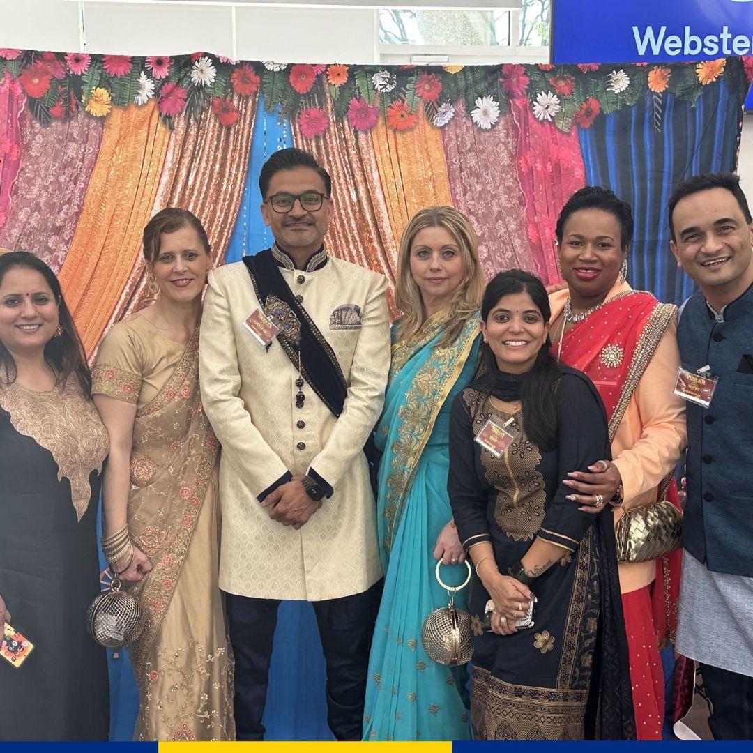 A group posed in AAPI cultural garments