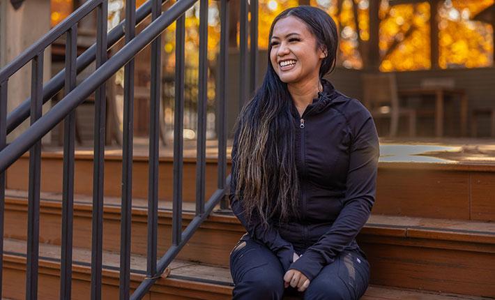 person smiling on steps