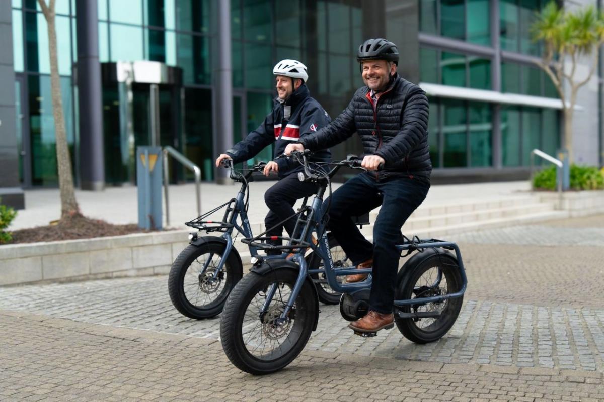 Pete Bowker and Daniel Usher riding e-bikes.