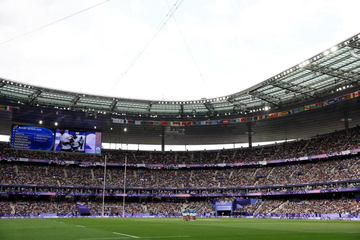 Wide view of a grassy-field and stadium