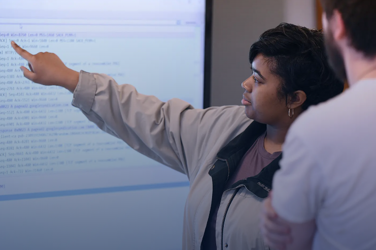 students working on a large screen