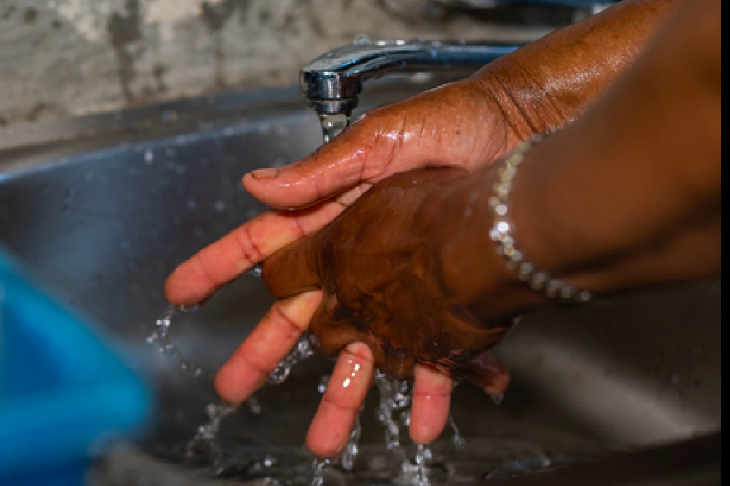 Handing being washed in sink