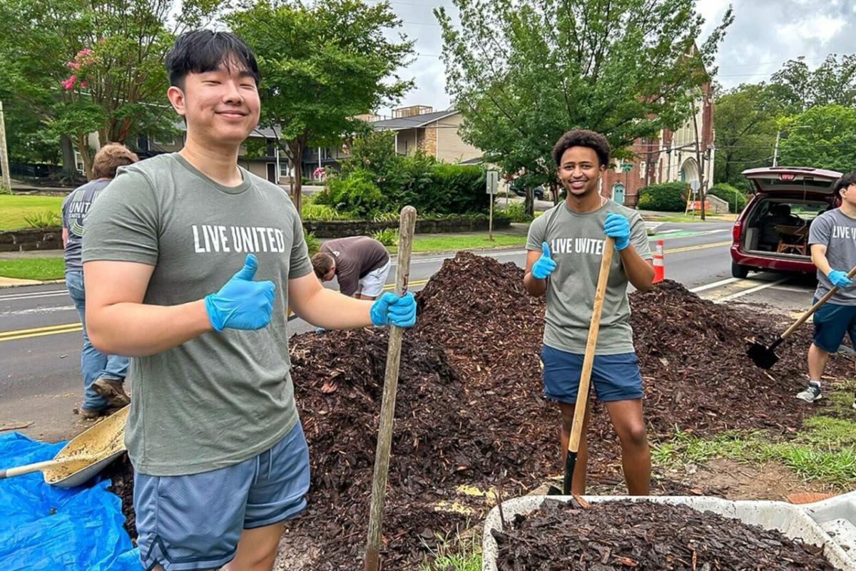 Two intern volunteers gardening.