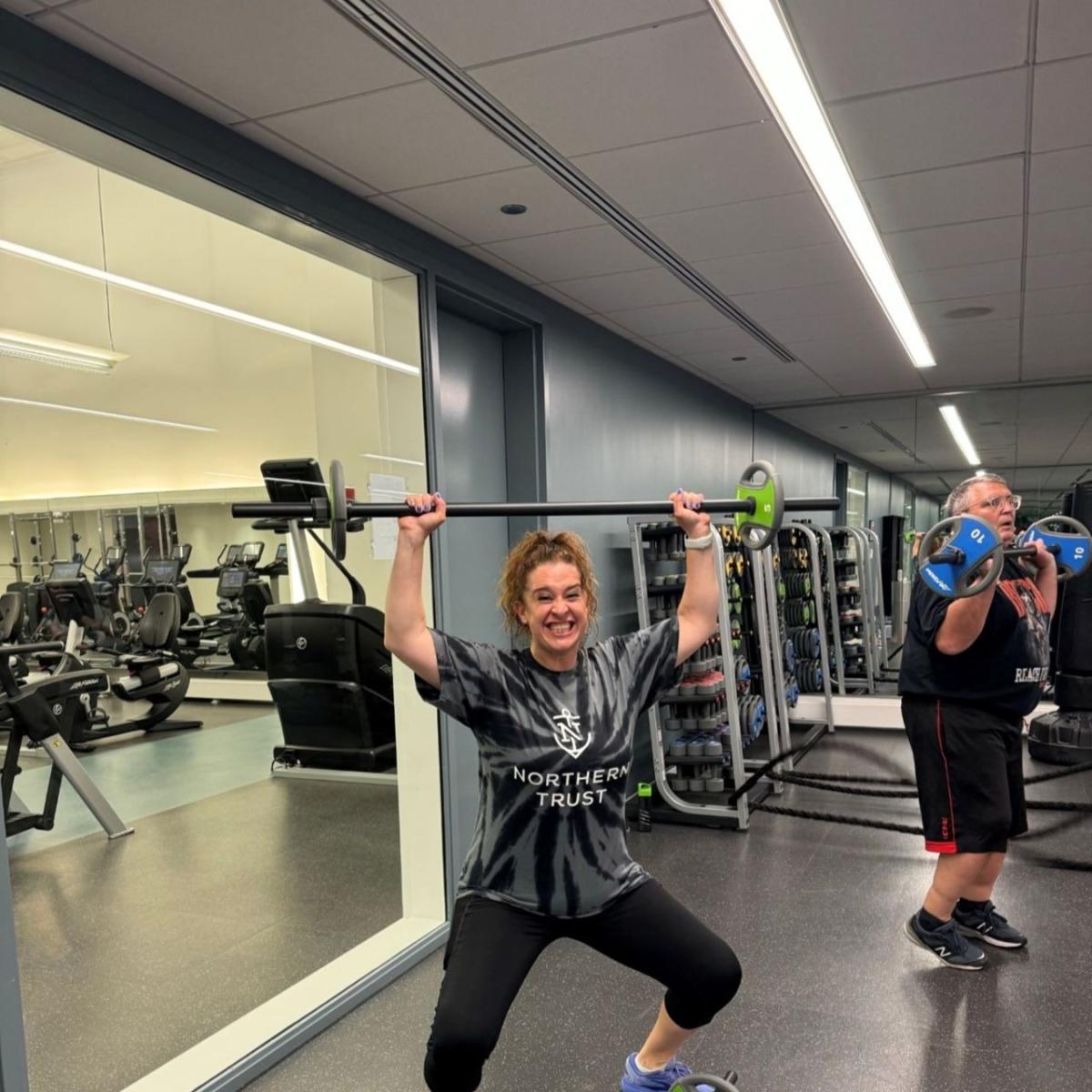 Two people lifting weights.