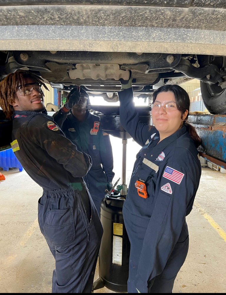 Student practicing vehicle maintenance 